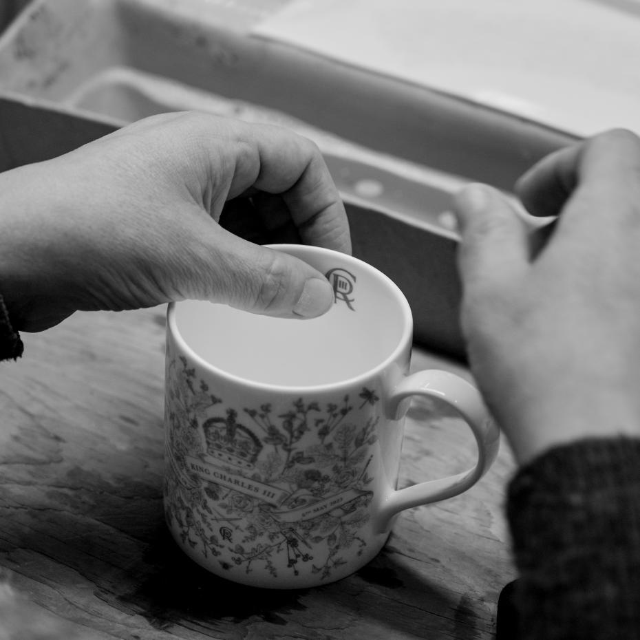 Adding the finishing touch, The King's cypher, to the King Charles III Coronation Mug